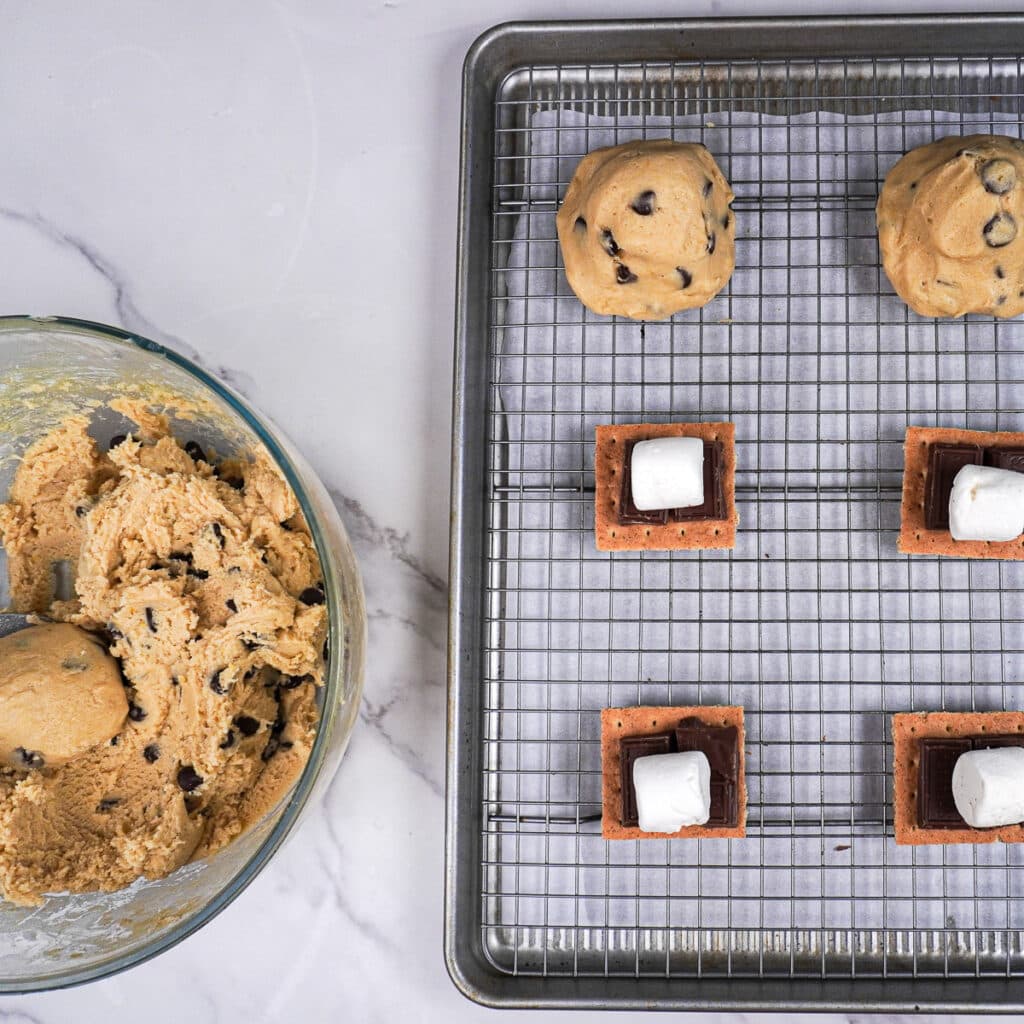 Assembling s'mores cookies on the baking sheet
