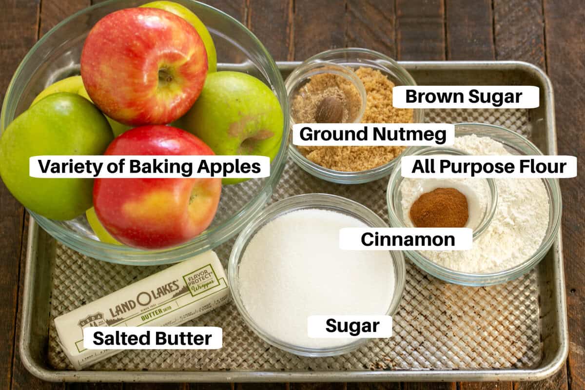 Apple crisp ingredients with labels on a metal sheetpan.
