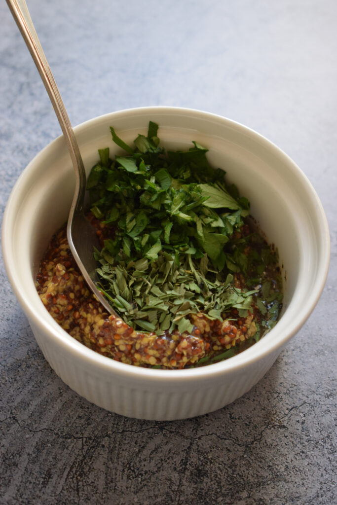 Ingredients in a small bowl to make a herb butter.