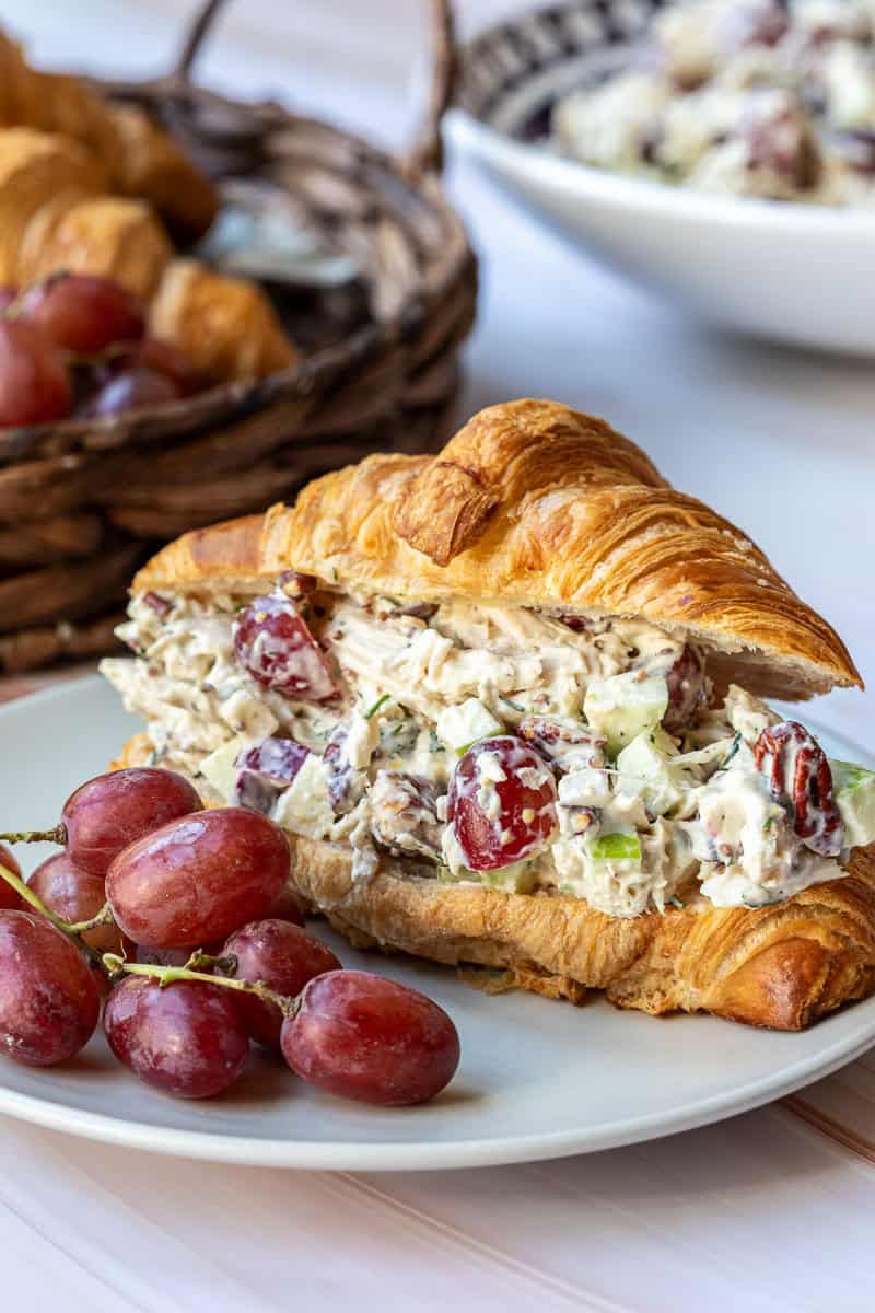 Delicious chicken salad croissant sandwich served with grapes
