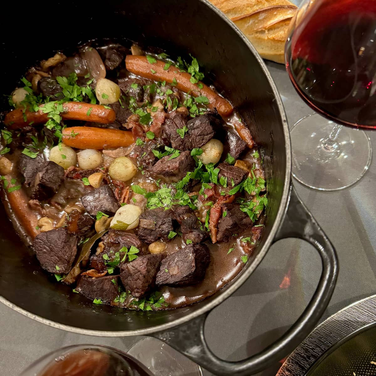 A large crock pot with French beef stew known as Boeuf Bourguignon