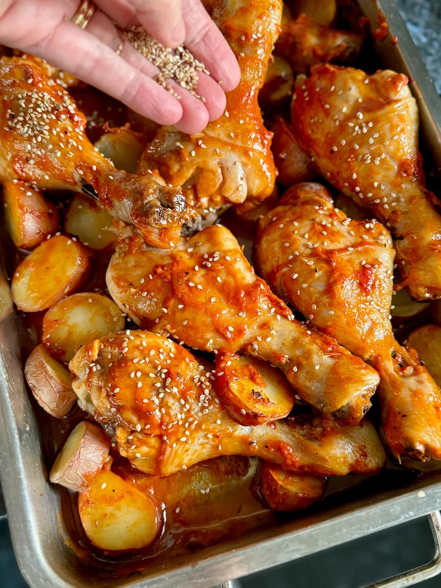 Sprinkling sesame seeds over chicken