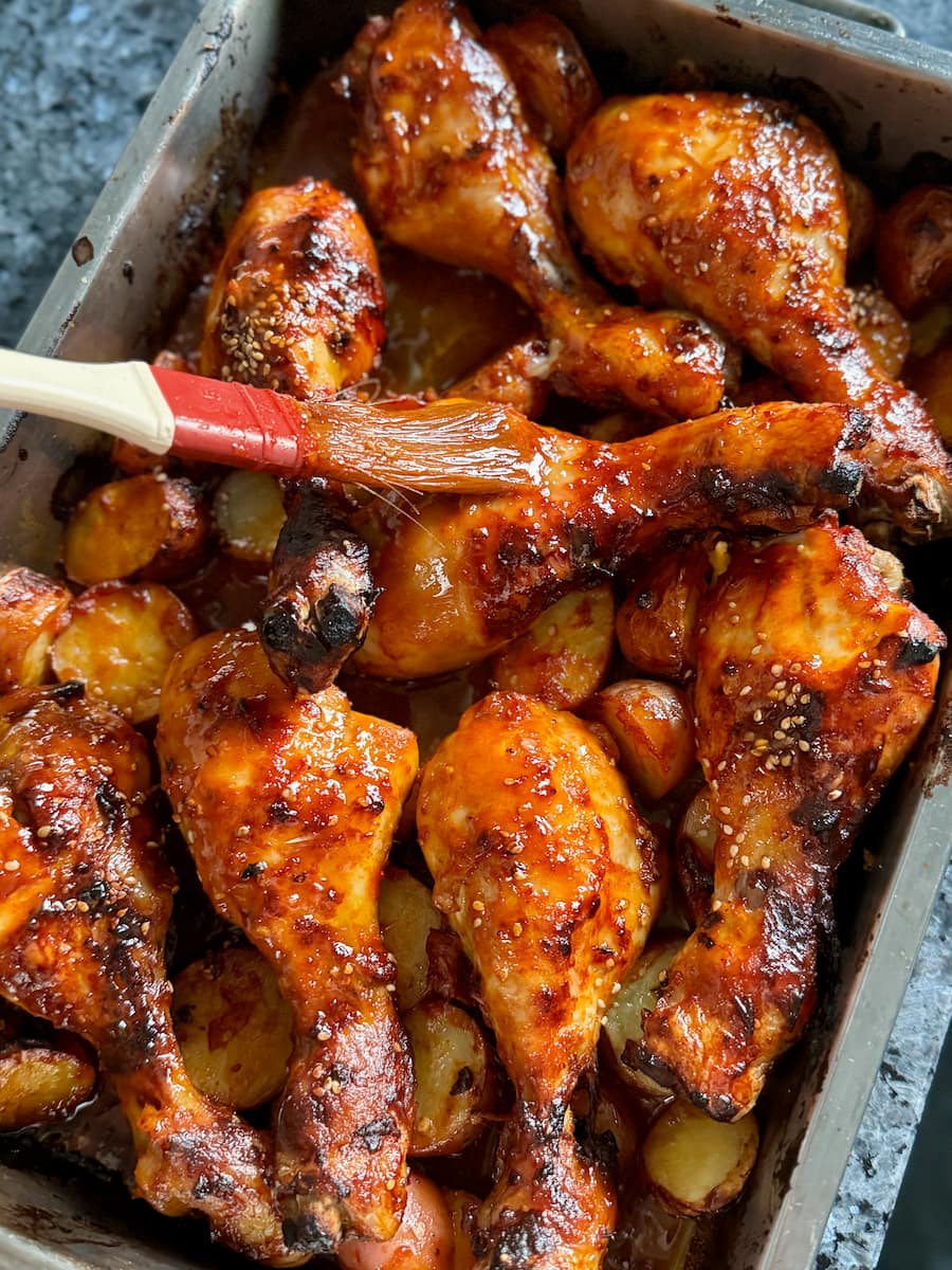 Glazing chicken drumsticks with sauce