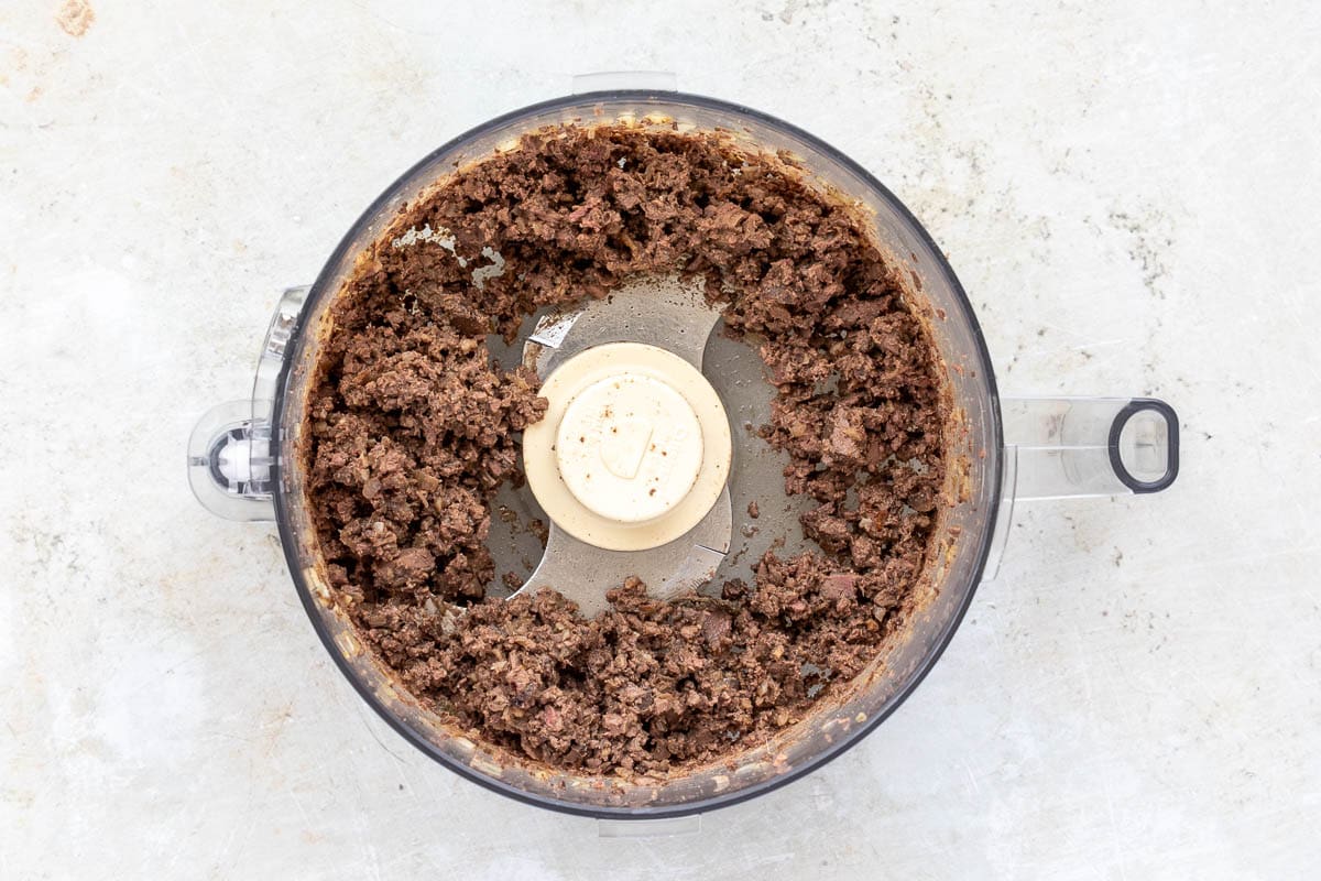 Chopped chicken livers and shallots in food processor.