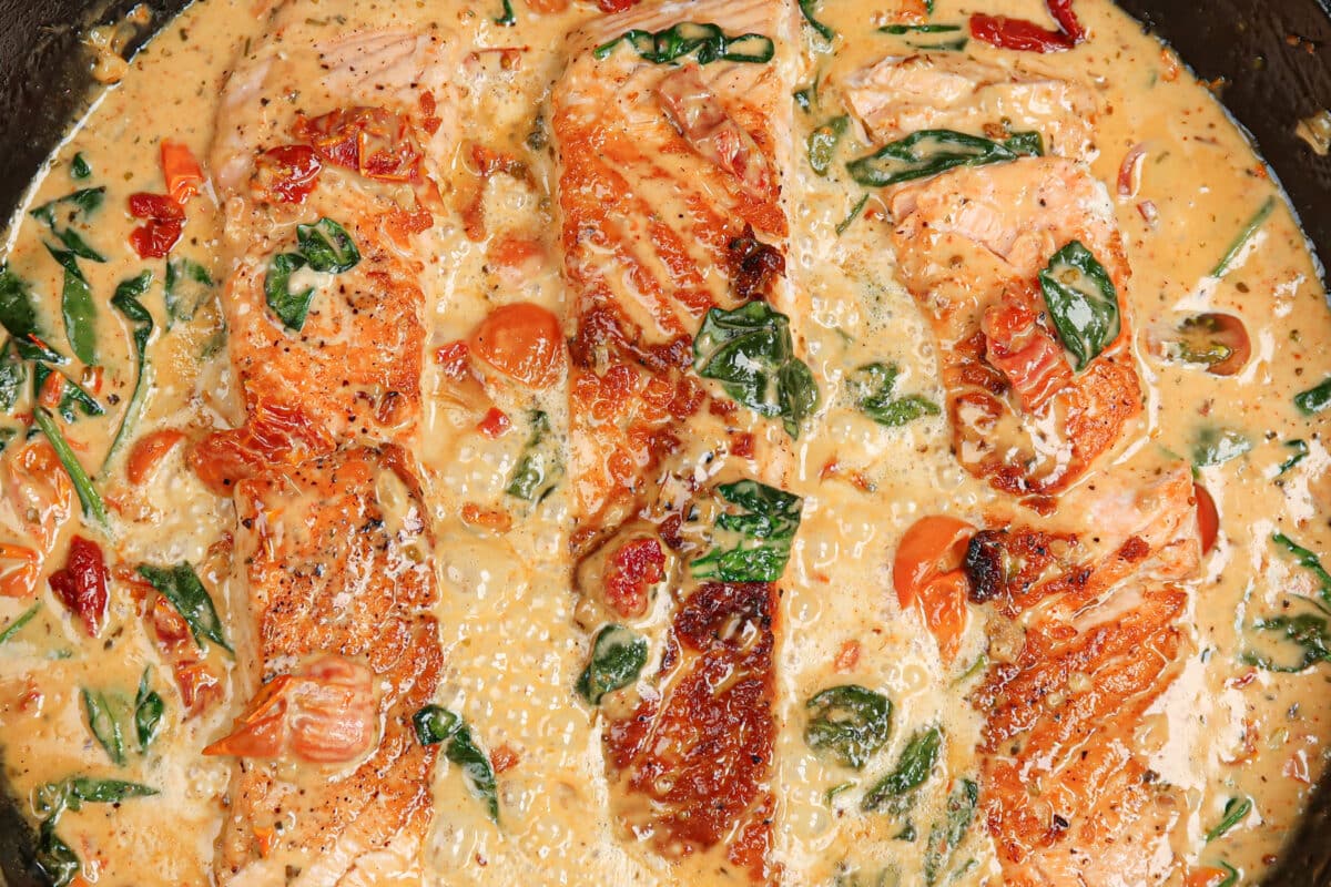 Simmering the salmon in the sauce