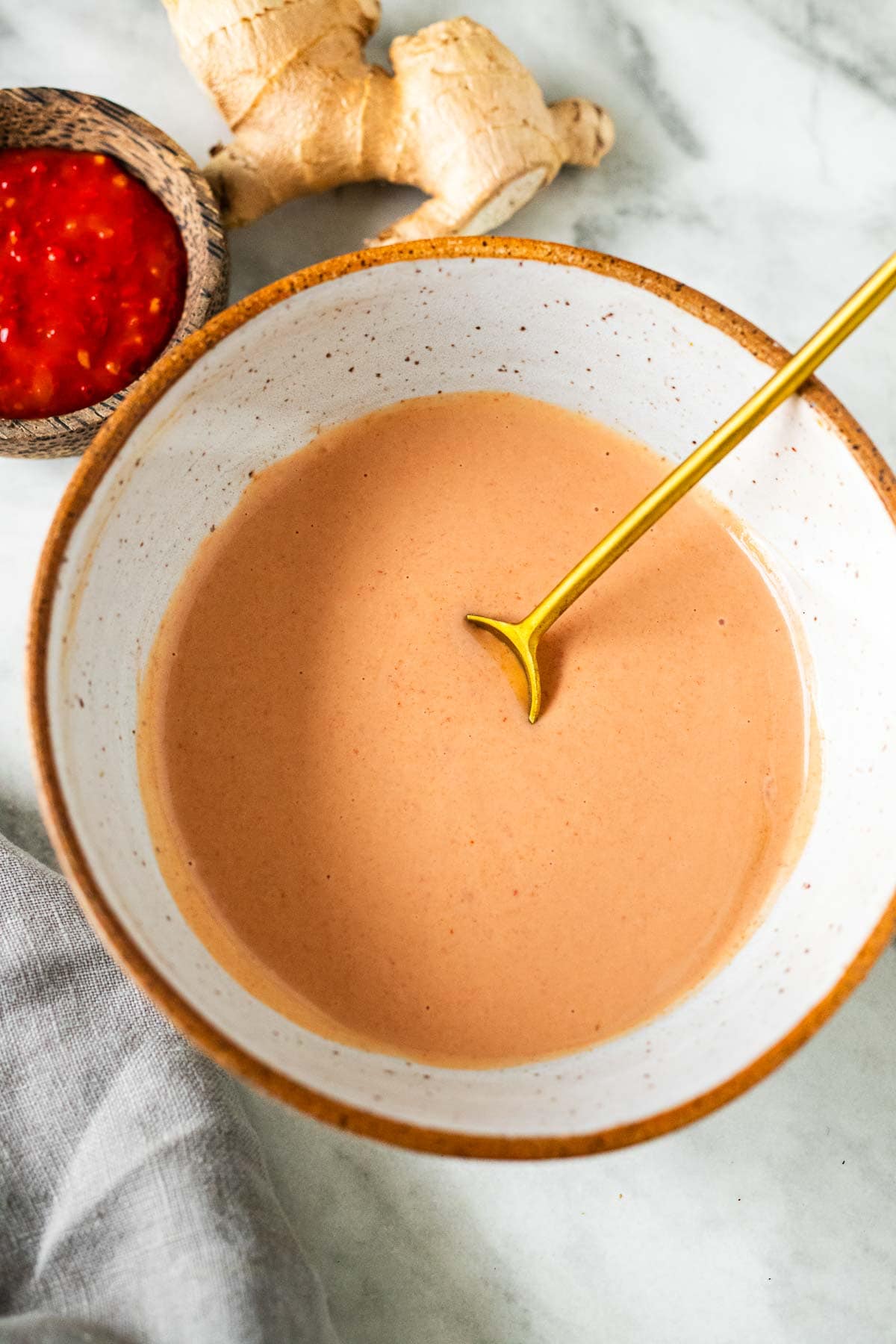 A bowl of Yum Yum Sauce with a gold spoon