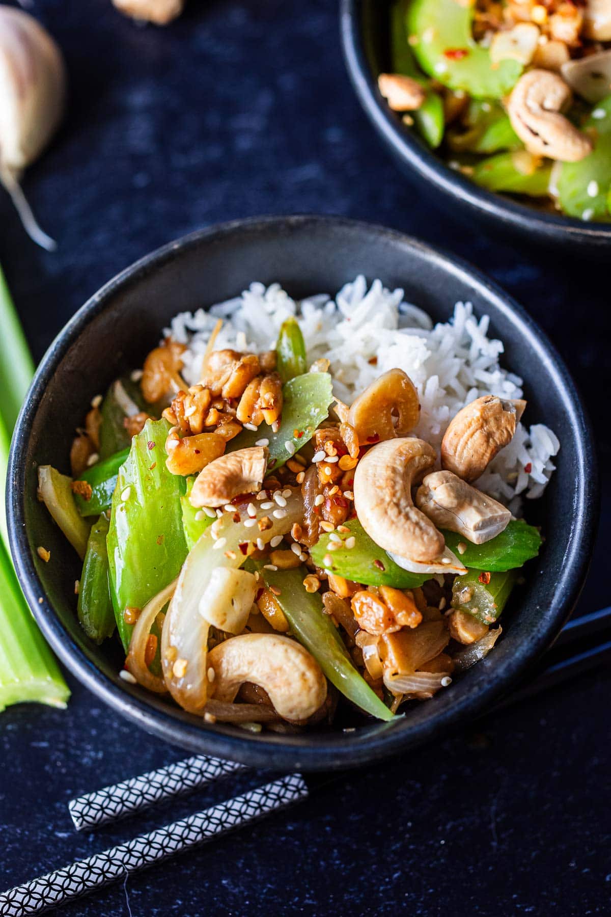 bowl of celery stir-fry over jasmine rice with cashews.
