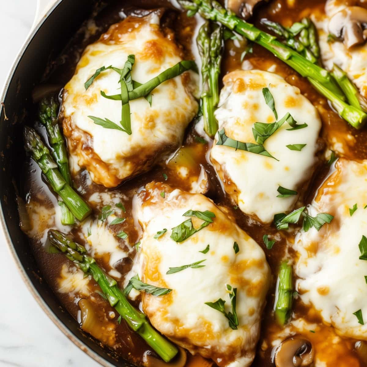 A delicious serving of Chicken Madeira in a skillet.