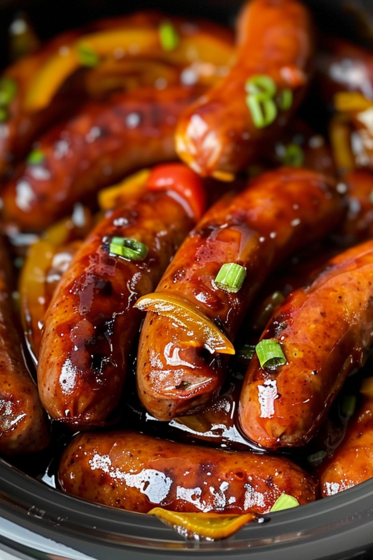 Lit’l Smokies cooked with savory gravy inside a black crockpot.