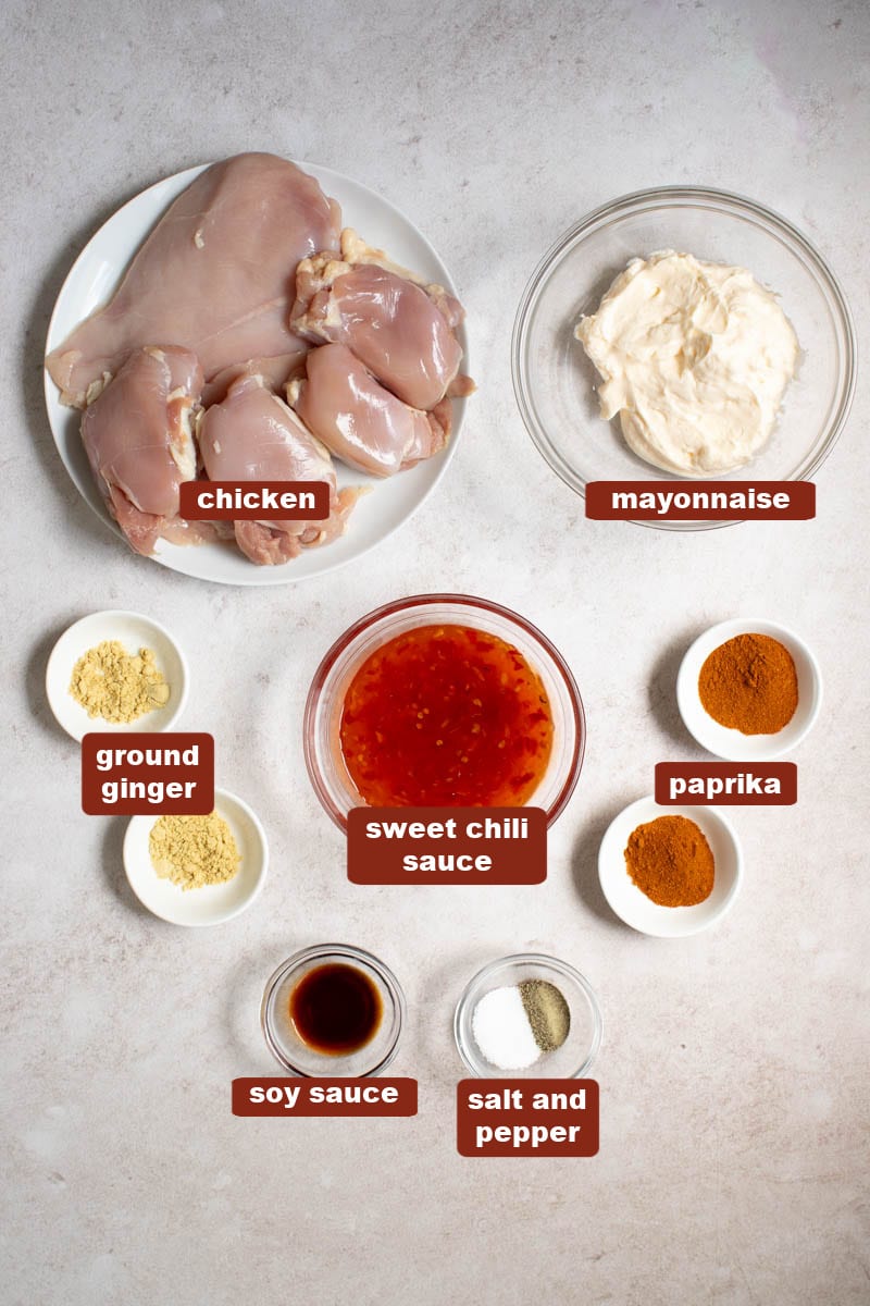 All of the ingredients for Bang Bang Chicken Skewers in bowls on a countertop.