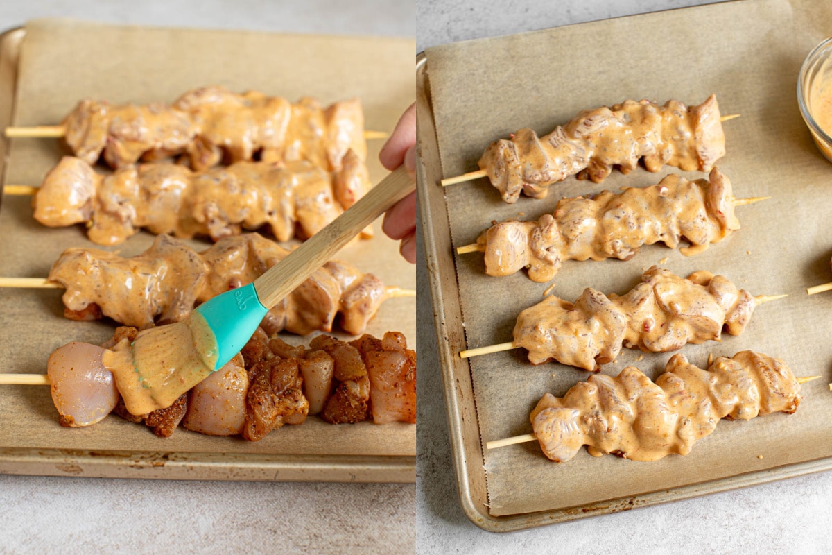 Basting the chicken skewers with Bang Bang sauce before baking on a sheet pan in the oven.