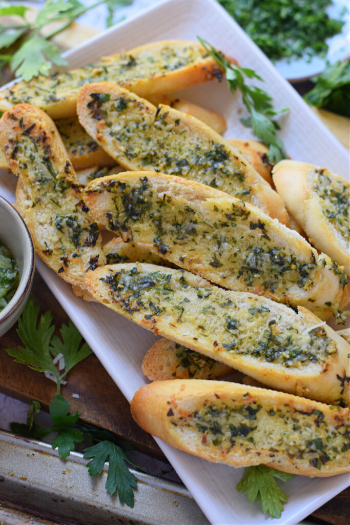 Garlic parmesan crostini on a white plate
