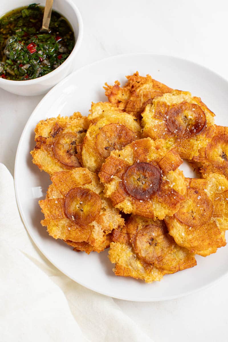 Fried green plantains served with chimichurri