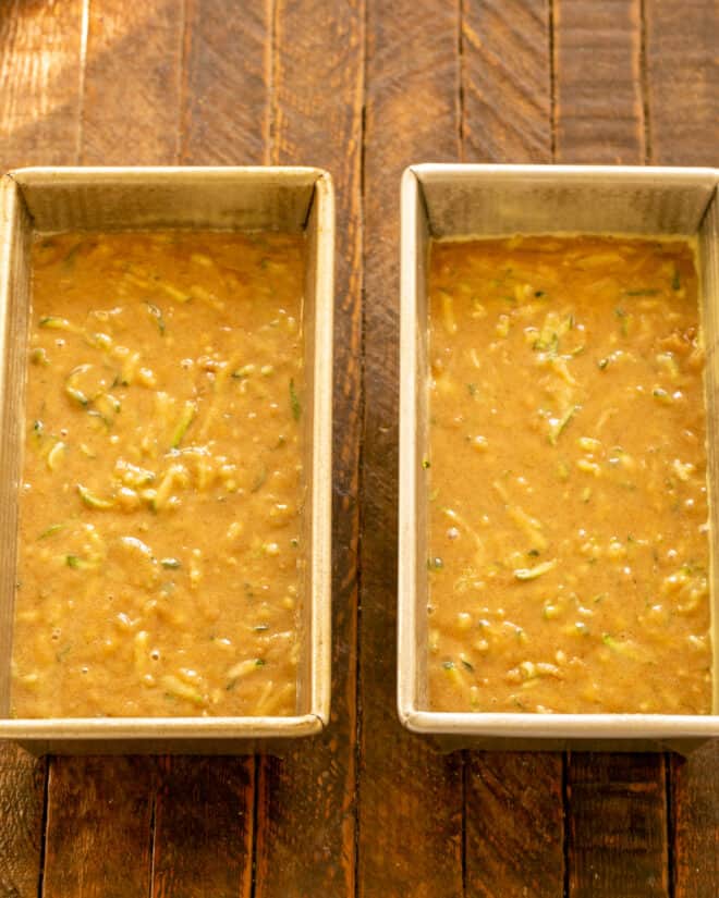 Dividing batter into prepared pans.
