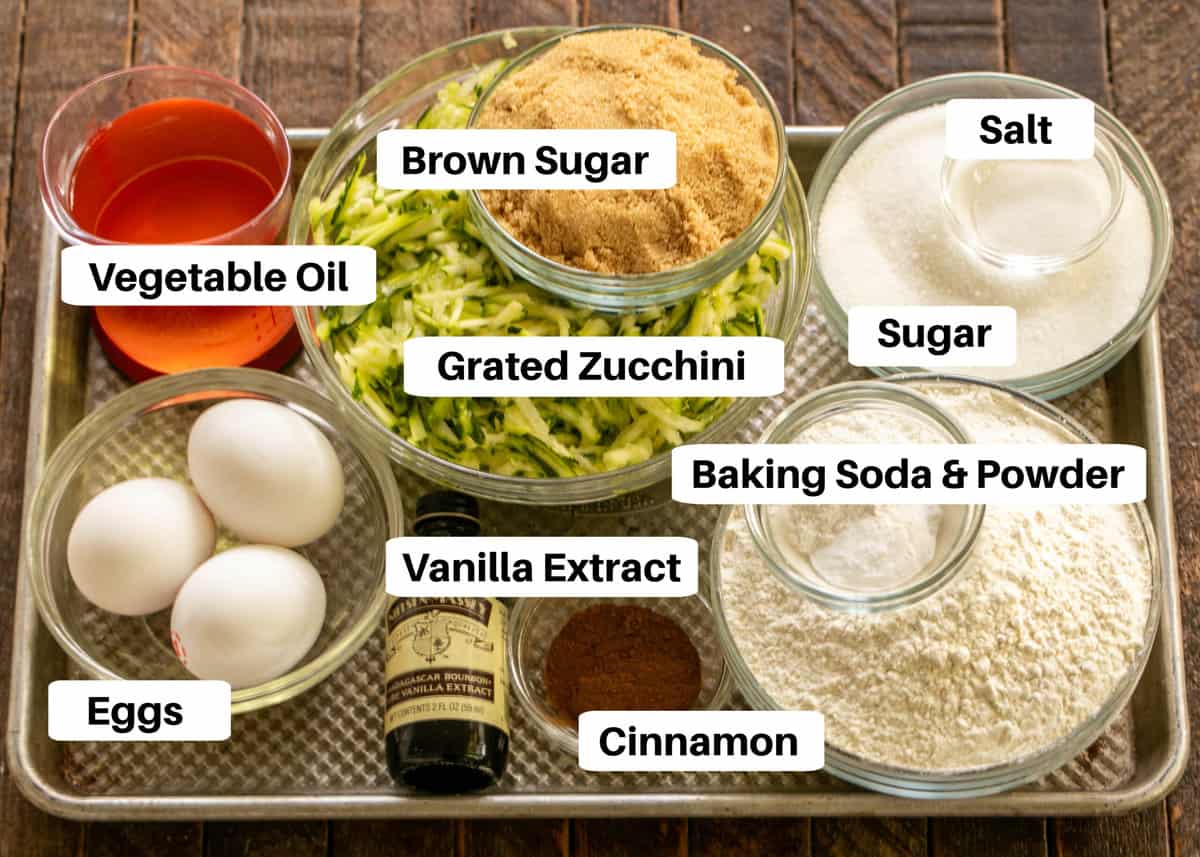 Zucchini bread ingredients on a sheet pan with labels.