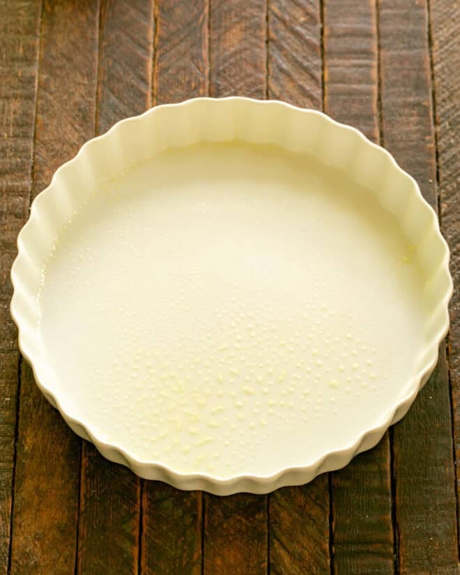 Grease baking dish and preheat the oven.