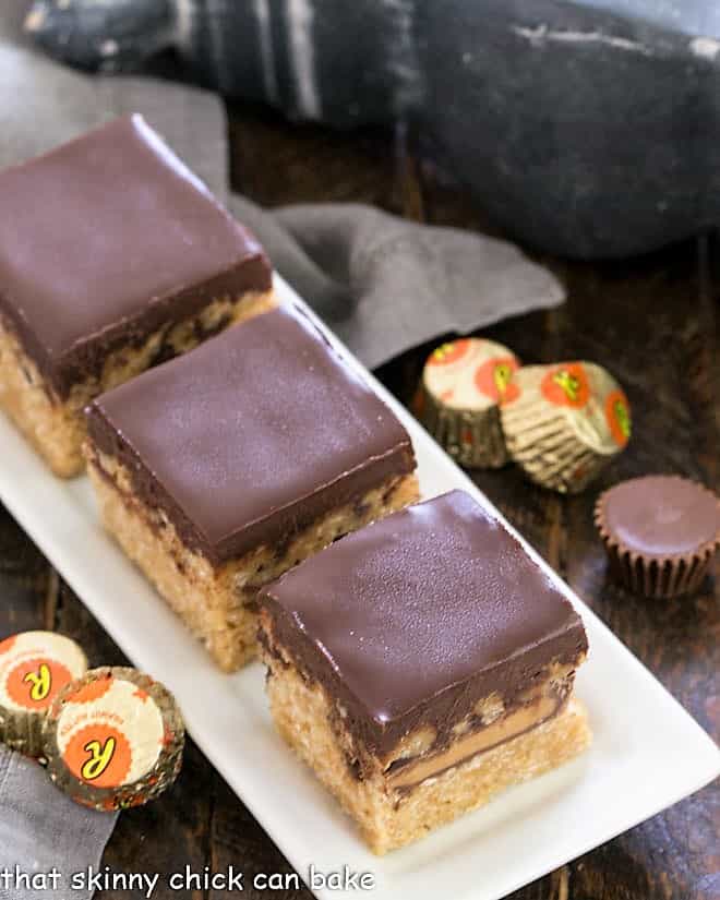 3 Stuffed Peanut Butter Rice Krispie Treats on a white ceramic tray