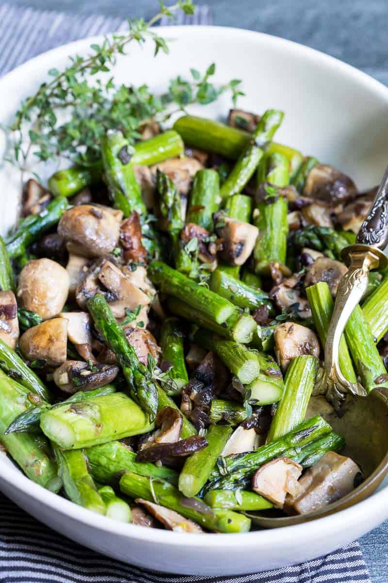 Sautéed asparagus and mushrooms garnished with fresh herbs