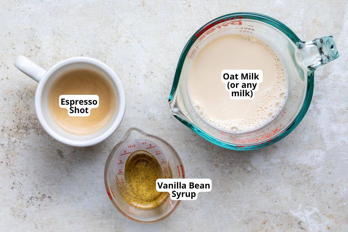 Essentials for a Vanilla Latte including espresso, milk, and vanilla syrup arranged neatly.