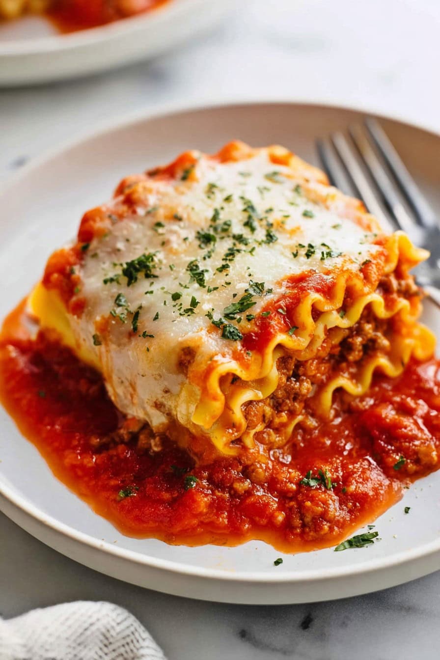 A serving of lasagna roll up on a plate.