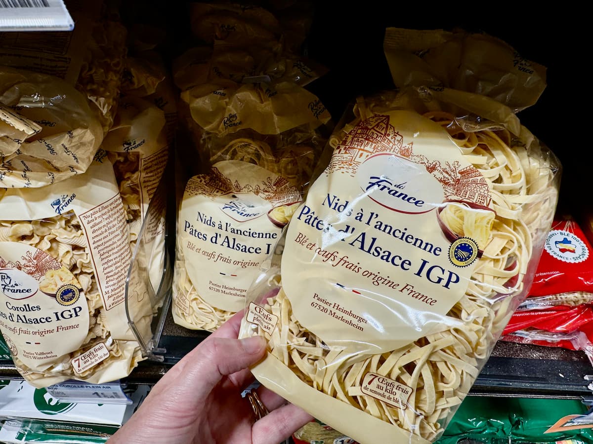 Holding a packet of dried pasta from Alsace