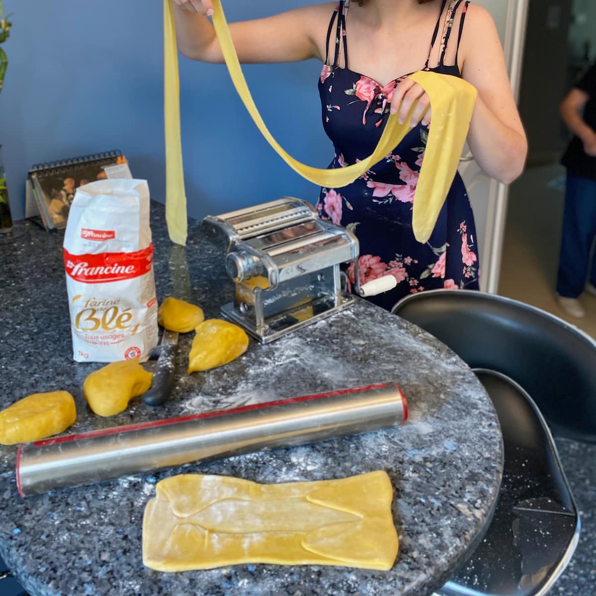 Stretching out pasta dough to create fresh egg noodles