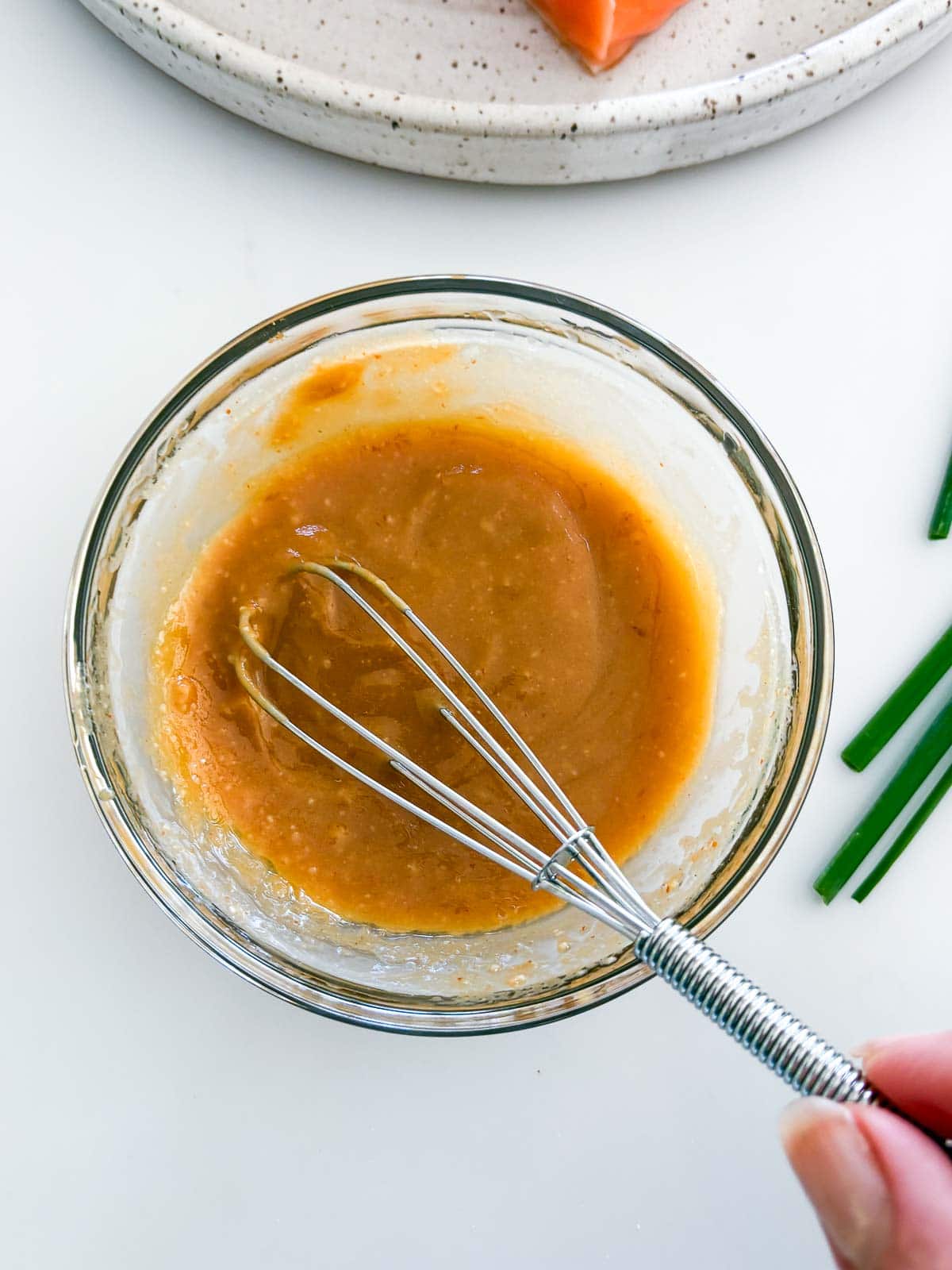 Small bowl of miso paste glaze with a whisk.