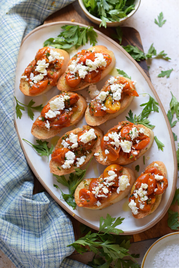 Tomato feta bruschetta on a white tray.
