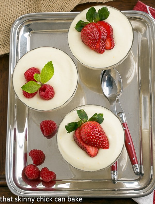Dreamy White Chocolate Mousse in glass parfait dishes on a silver tray.