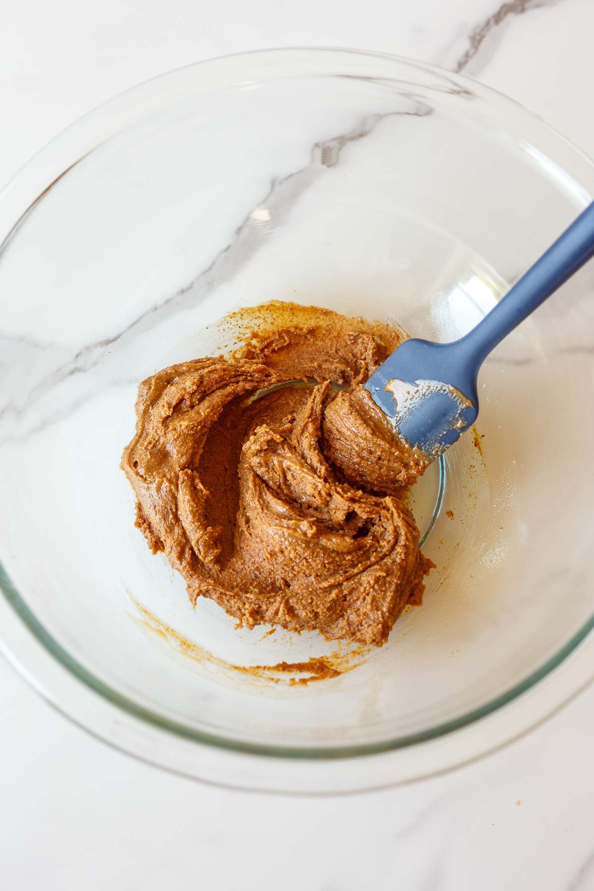Mixing almond butter with salt and vanilla