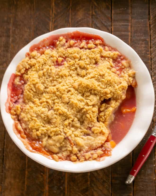 Peach Raspberry Crisp - A heavenly summer dessert that's easy and unforgettable! Peach Raspberry Crisp in a white porcelain pie plate.