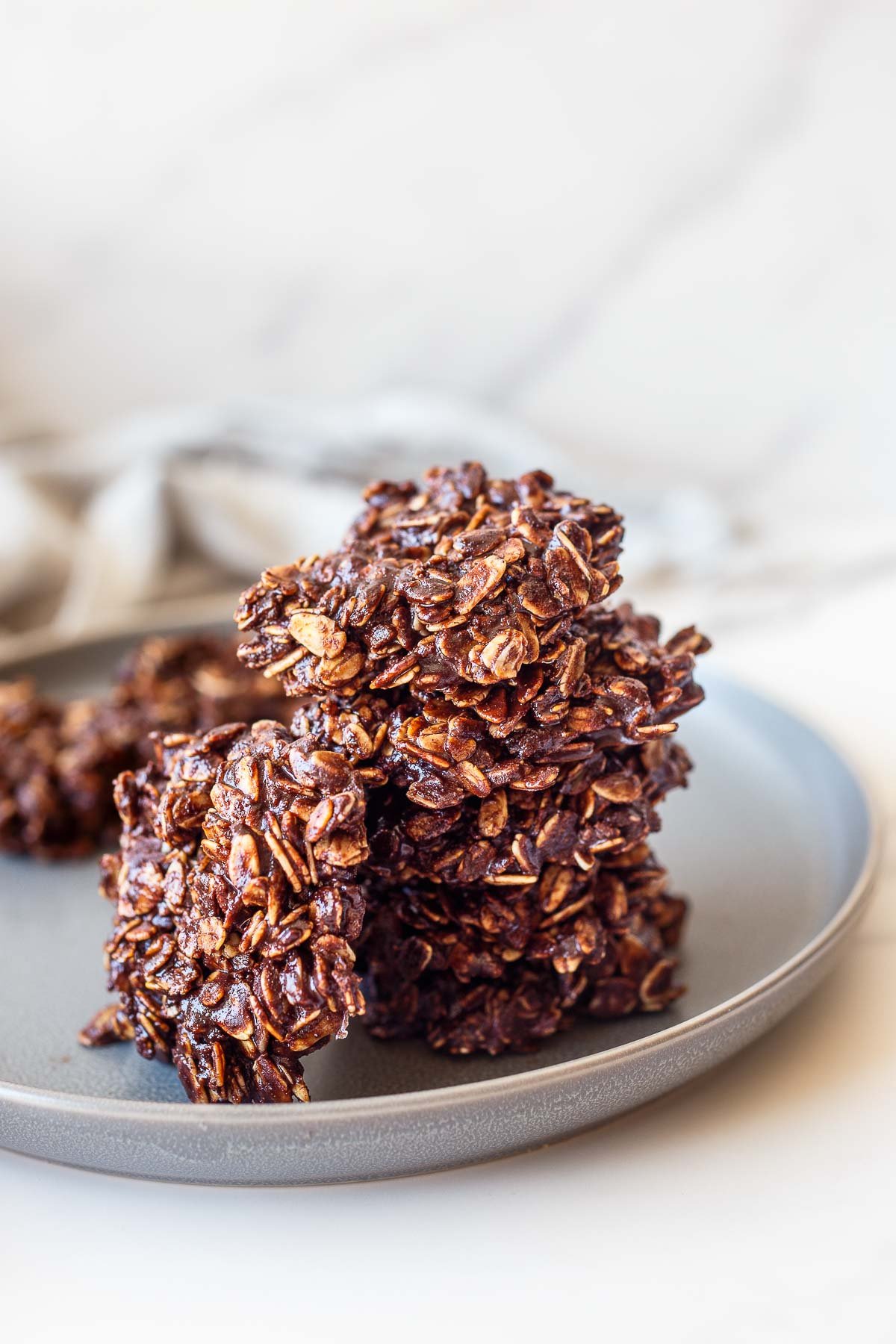A plate showcasing a stack of chocolate no-bake cookies
