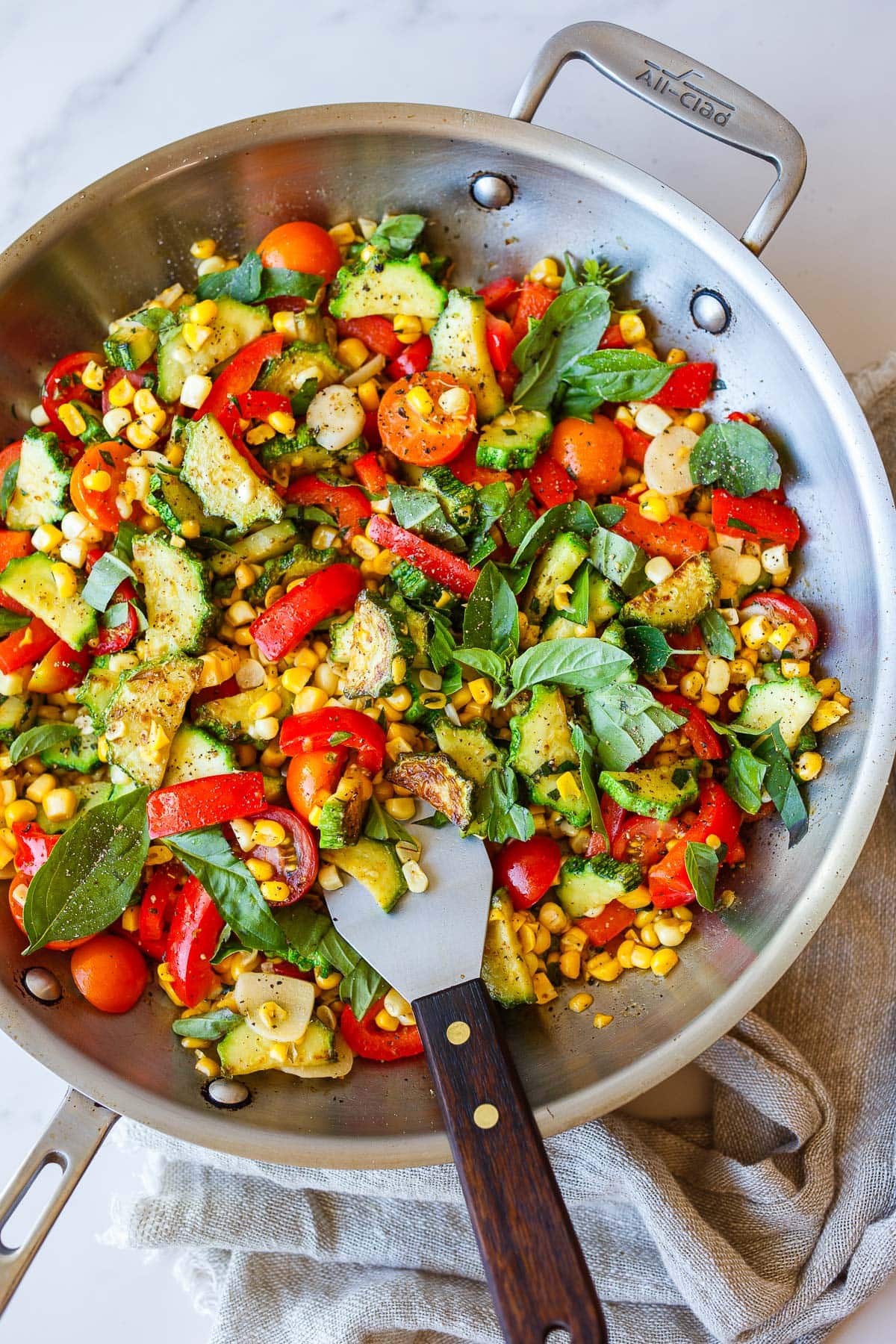 Sautéed zucchini with bell peppers, corn, cherry tomatoes, and basil.