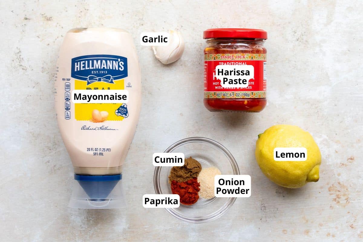 Ingredients for Harissa Aioli including mayonnaise, harissa paste, garlic, lemon, and different spices.